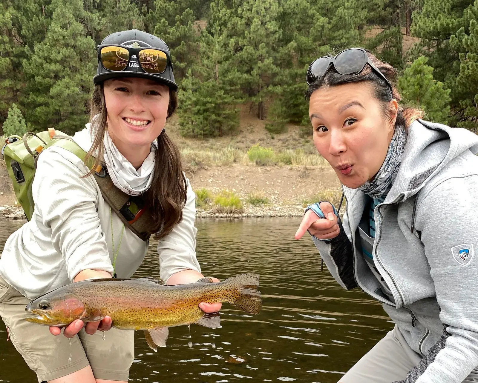 Guide holding a trout caught on a Lake Tahoe fly fishing tour